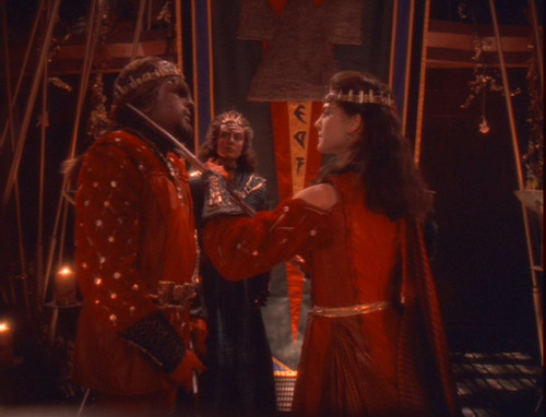 Scene from wedding ceremony where Jadzia holds a bat'leth to Worf's throat