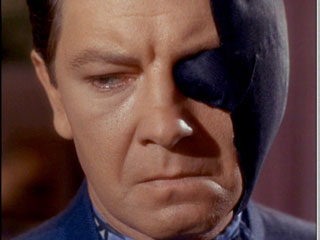 Doctor Thomas Leighton with a black bandage on the left side of his face
