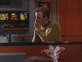 A flower sprays Kirk with spores on the Enterprise bridge