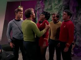 Kirk holds Uhura by the shoulders