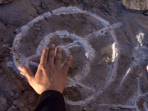Chakotay's hand touching strange symbol 