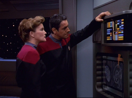 Janeway and Chakotay examine a computer terminal