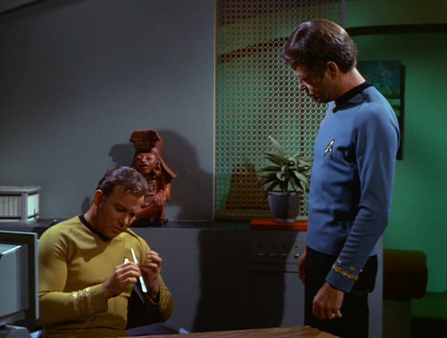 Kirk files his nails while Spock watches