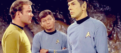 GIF of Spock falling over into Kirk and McCoy's arms