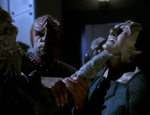 A Jem Hadar chokes Garak while Worf tries to intervene