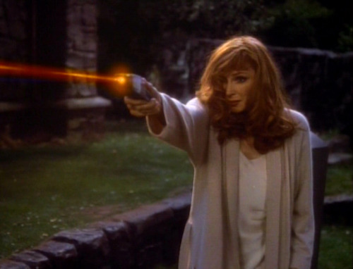 Beverly fires a phaser in the cemetery