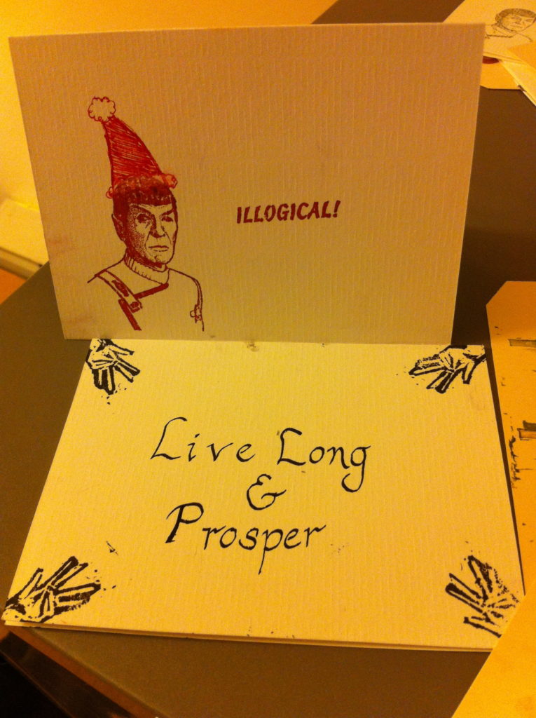 Card with stamp of Spock in a Santa hat saying "illogical" and another card with stamped Vulcan hands and "Live Long & Prosper"