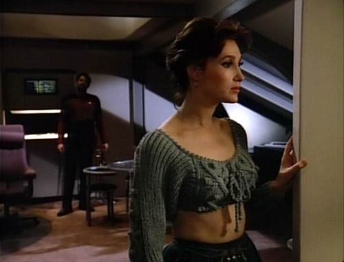 Brenna in her crop top sweater in Riker's quarters