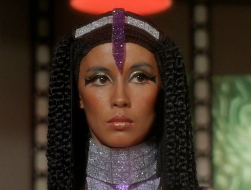 Elaan's face, with Cleopatra-esque hair, Egyptian-inspired eye makeup, and a purple tiara