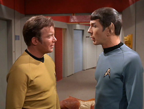 Kirk and Spock talk in the corridor