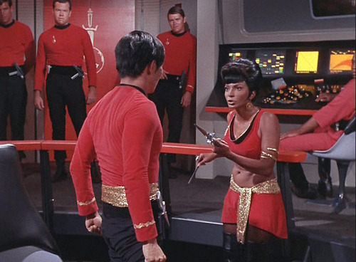 Uhura holds a dagger pointed at Mirror Sulu