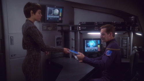 T'Pol hands a PADD to Archer