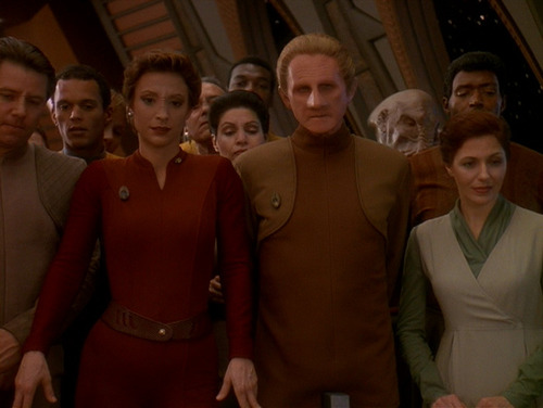 Kira and Odo stand in a crowd on the Observation Deck