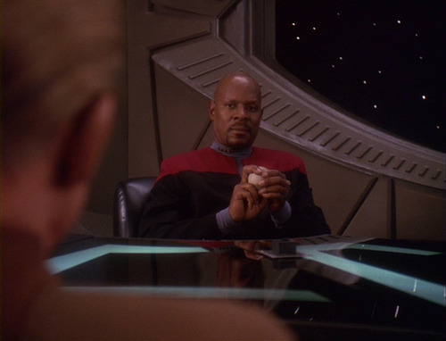 Sisko holds his baseball and talks to Odo