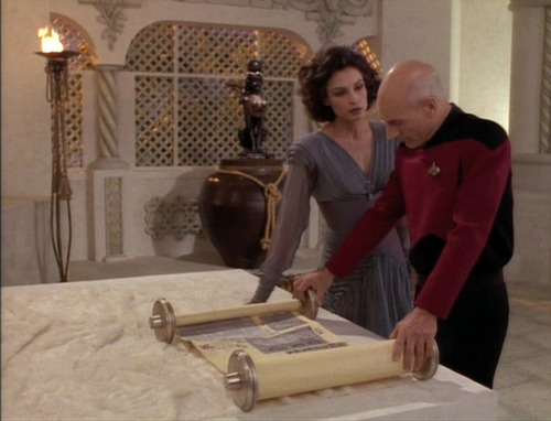 Picard and Kamala look over wedding plans on scrolls
