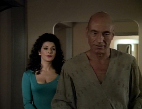 Troi stands behind Picard as he readies for his trip