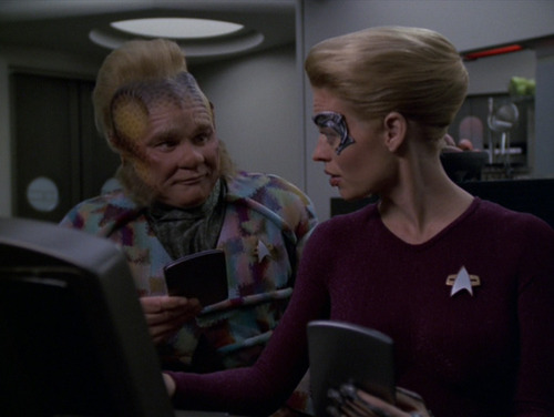 Neelix and Seven look at a computer in the Mess Hall