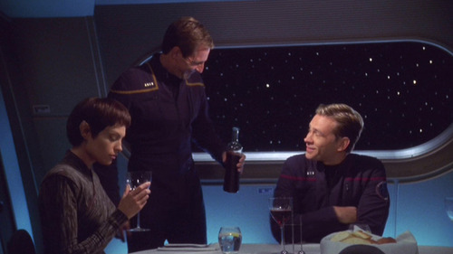 Archer pours wine for T'Pol and Trip