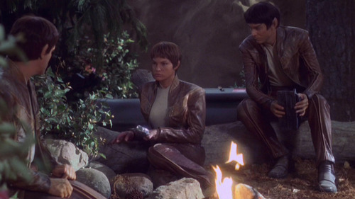 T'Mir and her Vulcan crewmates sit around a fire in the woods