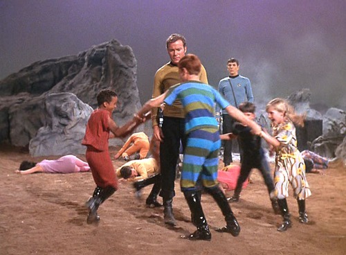 Kids dance in a circle around Kirk