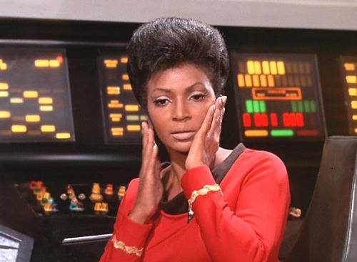 Uhura touches her face with relief