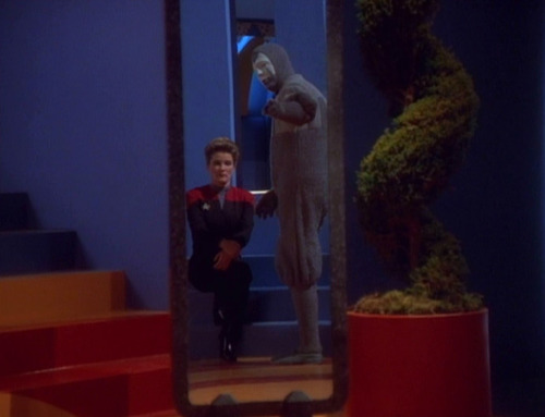 The Clown points to himself and Janeway in a mirror