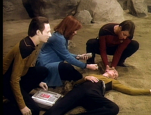 Data, Crusher and Riker examine a fallen Yar in "Skin of Evil"