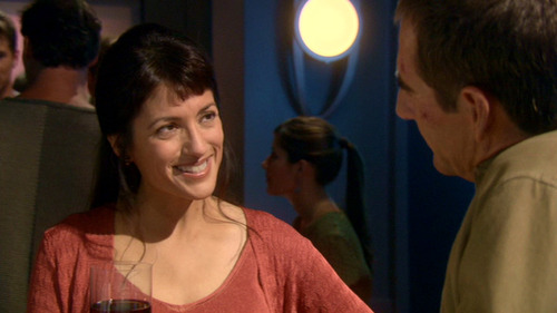 Erika smiles at Archer at the bar