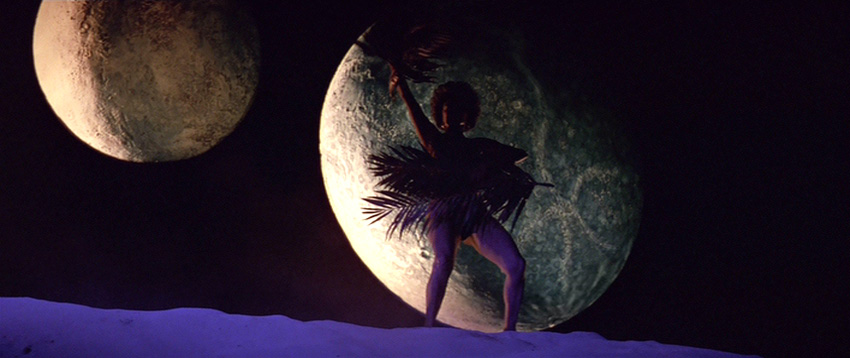 Uhura silhouetted against a moon with fans