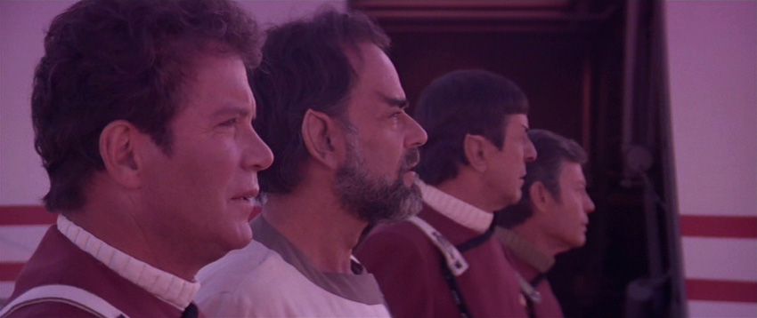 Kirk, Sybok, Spock and McCoy bathed in purple light