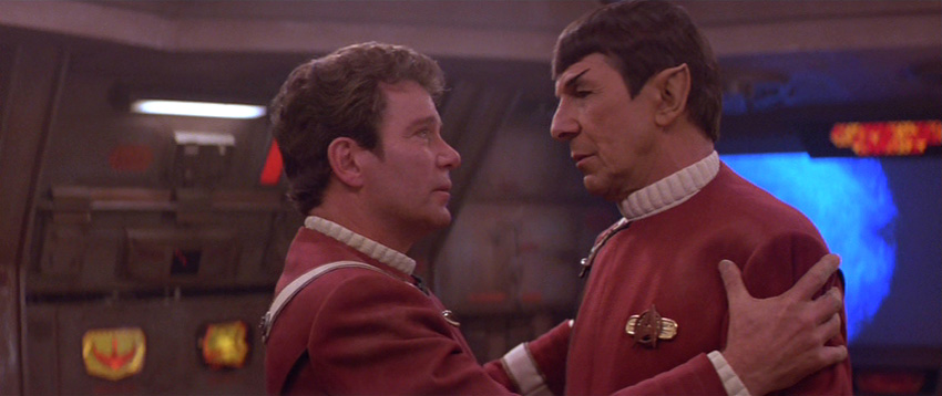Kirk grasps Spock's shoulders