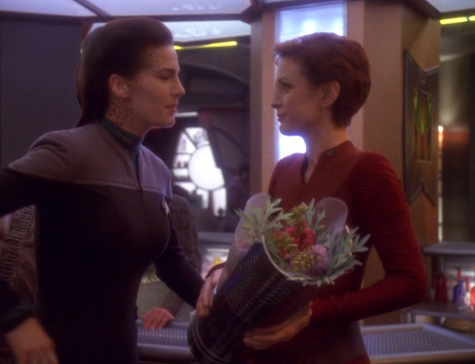 Dax talks to Kira, who is holding flowers