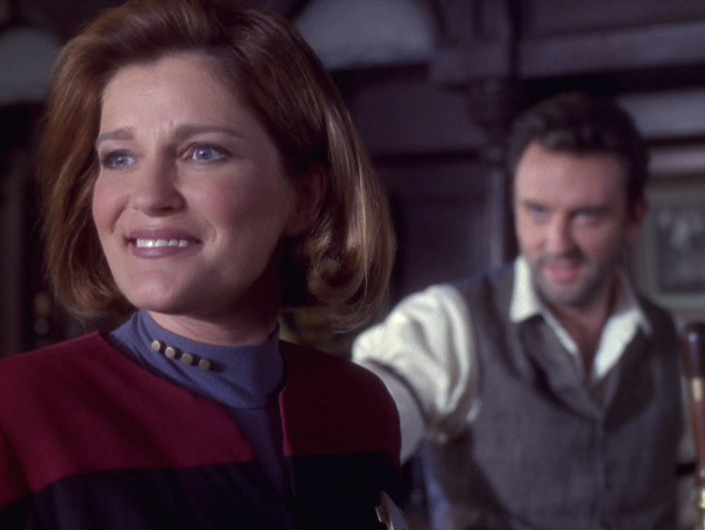 Janeway smiling with Michael in the background