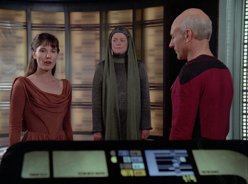 Salia and Anya arrive and greet Picard in the transporter room
