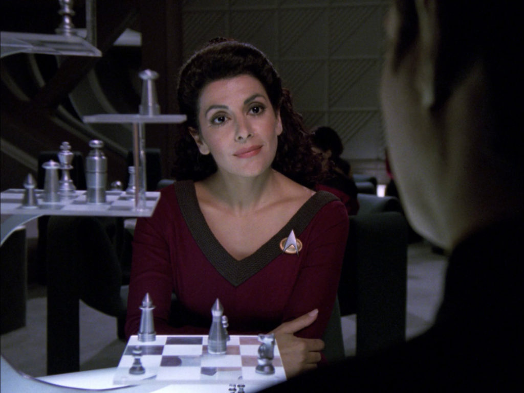 Troi stares at Data across the 3D chess board