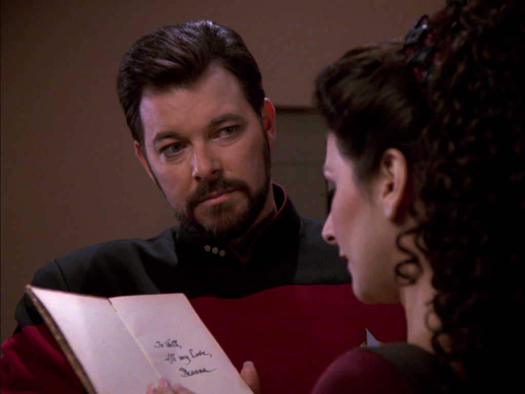 Troi reads the dedication in the book of poetry she gave to Will