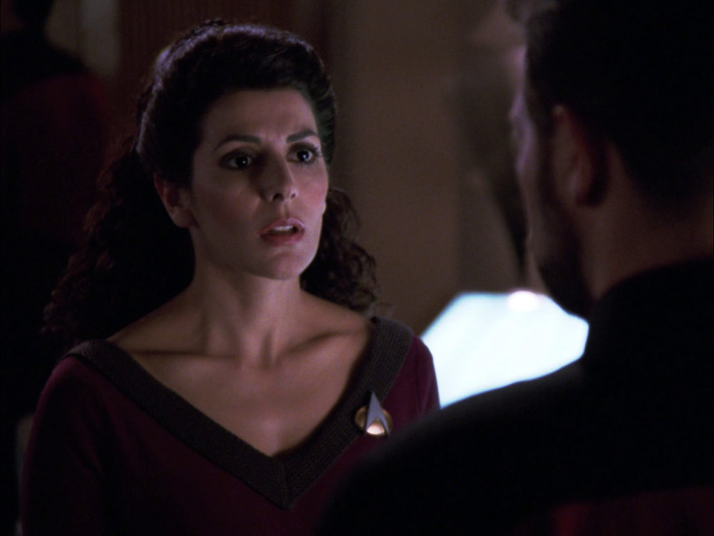 Troi stares at Riker with recognition