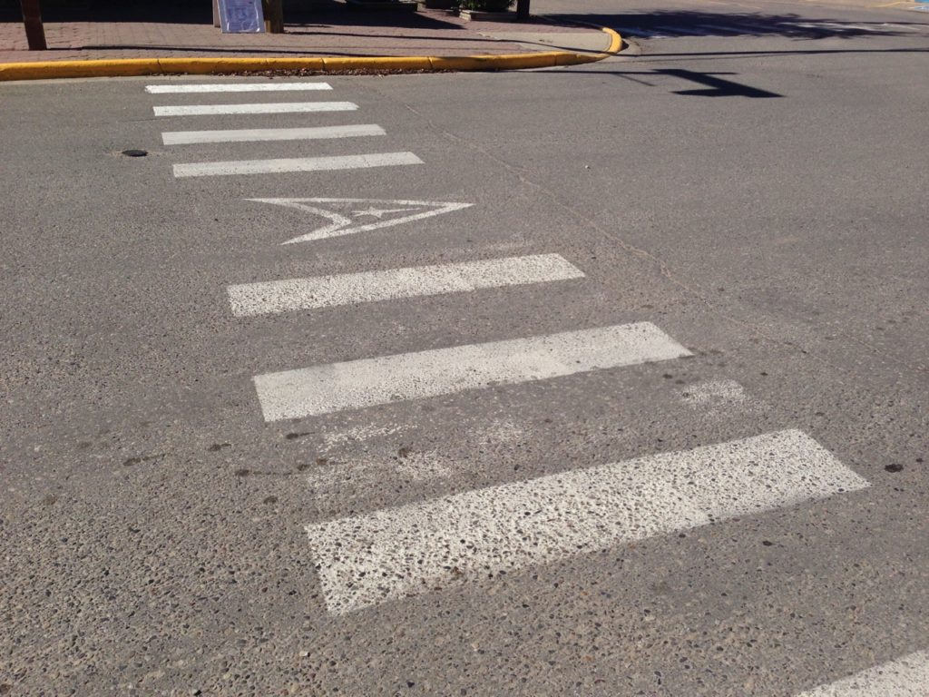 Crosswalk with Delta Shield painted in the middle