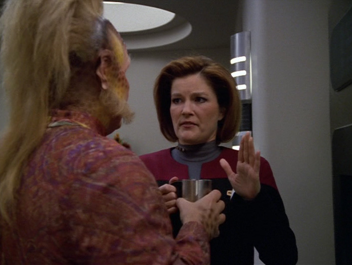 Janeway holds her hand up to stop Neelix talking before coffee