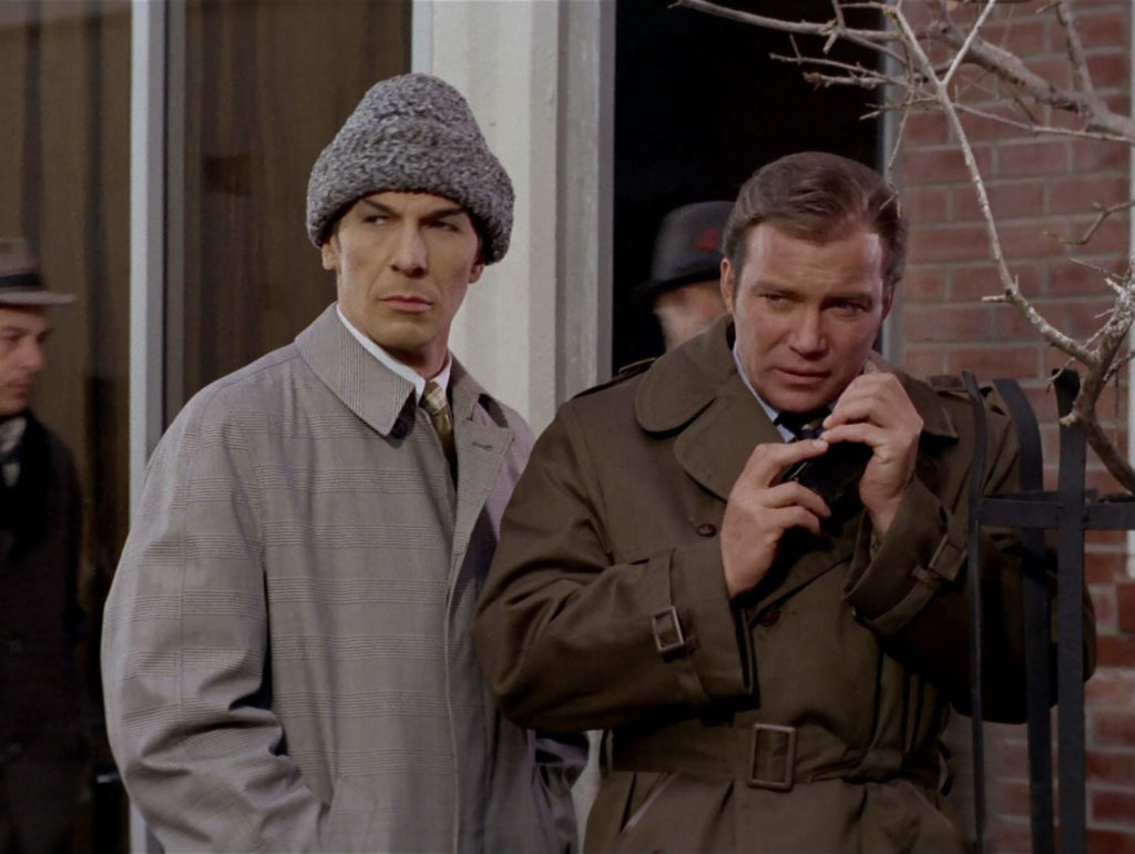 Spock and Kirk in trenchcoats with Spock in a grey, heavy winter beanie