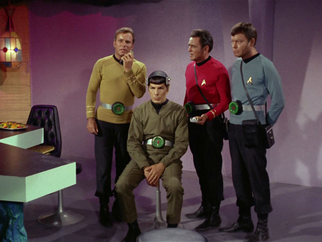 Kirk, Scotty and McCoy stand behind Spock in his brainless state