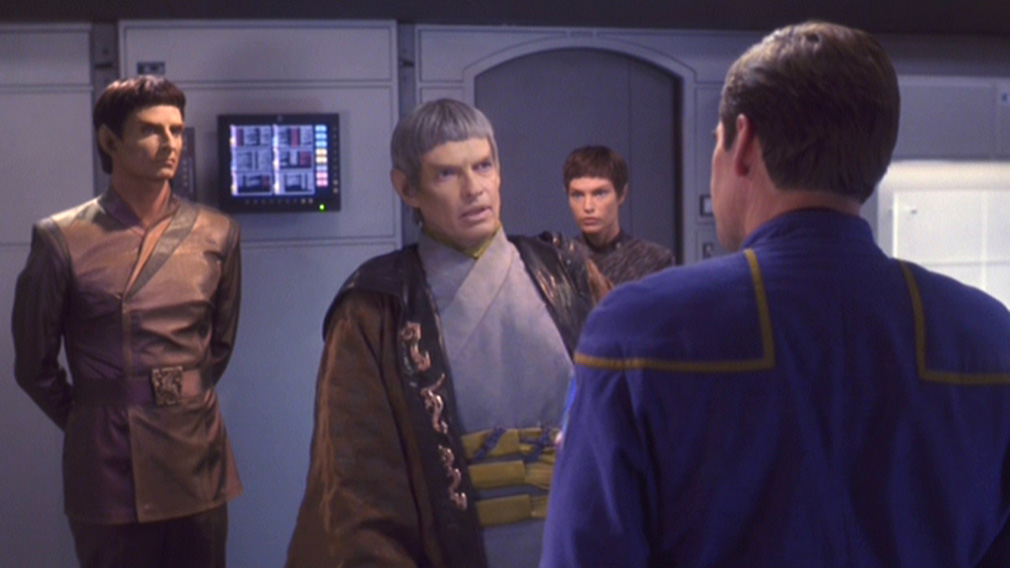 Soval and an aide talk to Archer as T'Pol looks on