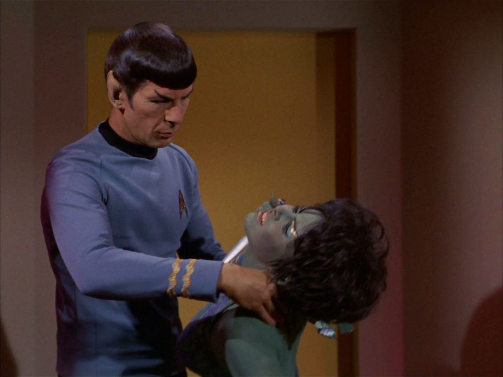 Spock subdues Marta with a neck pinch